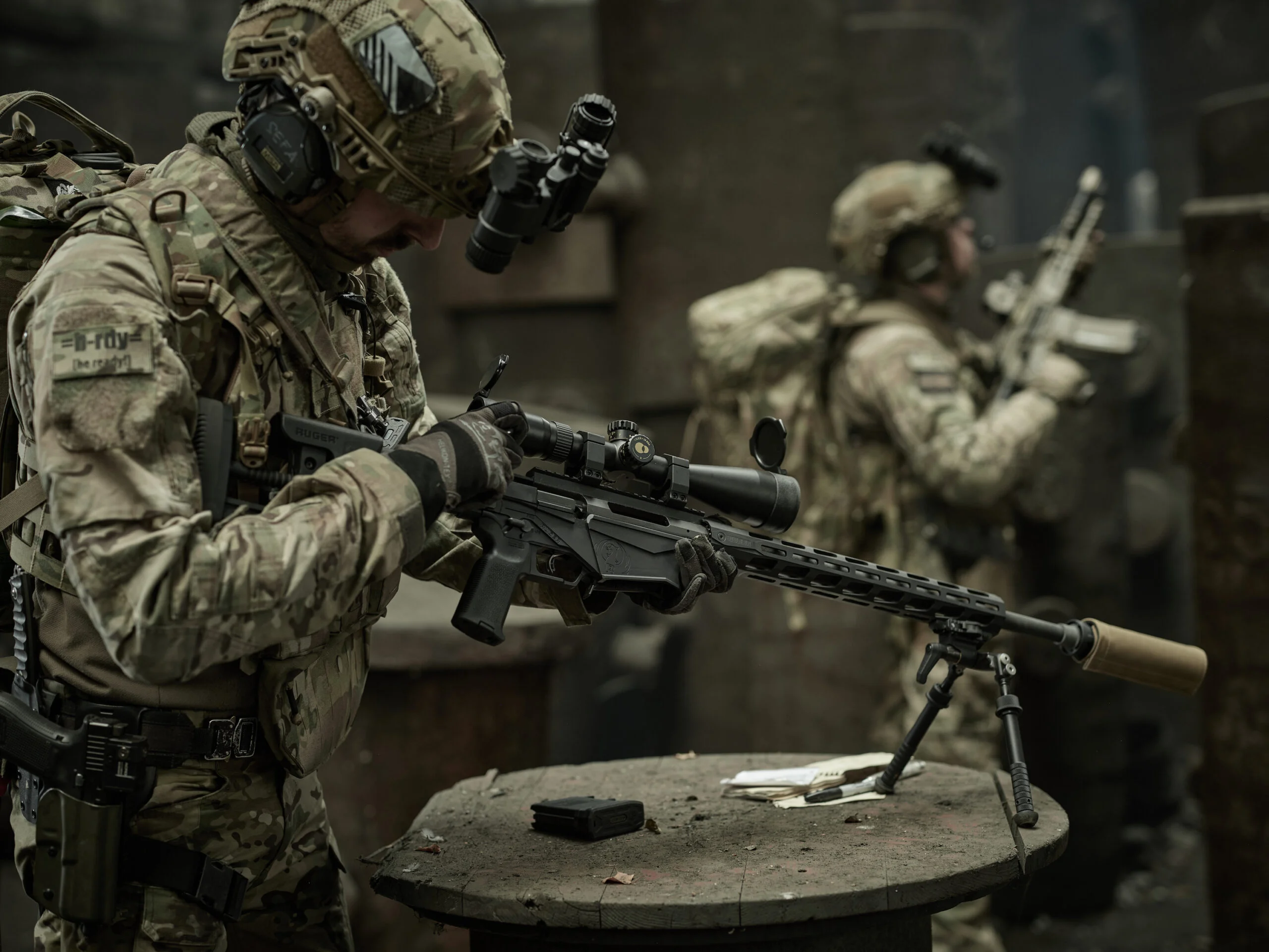 Soldiers in the field with rifles mounted on bipods